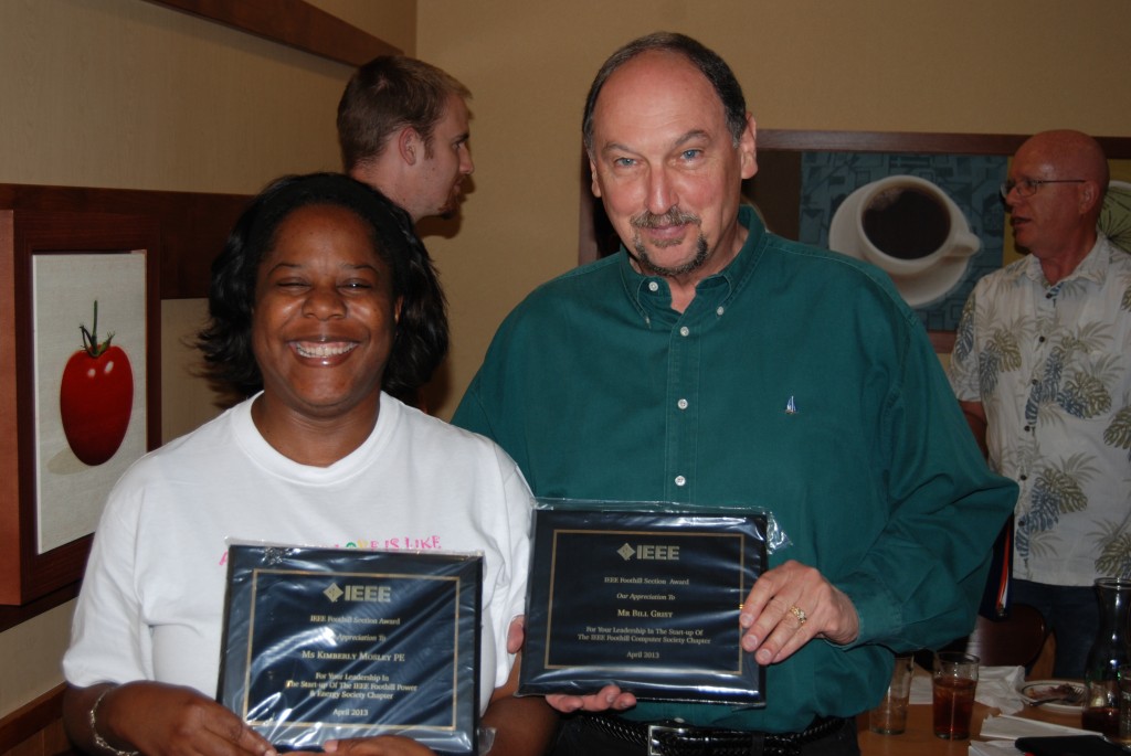 Smiles of Accomplishment: Signs of IEEE Volunteers Being Awarded